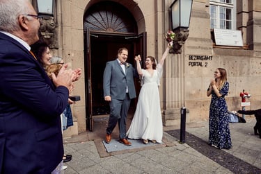 Newlyweds exiting the Tempelhof-Schöneberg civil registry in Berlin.