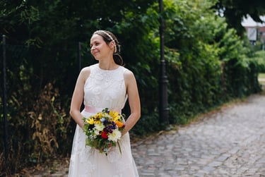 Bride holding a bouquet looking to the side.