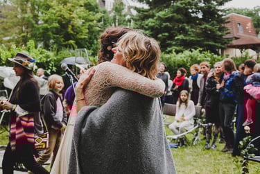 Bride being congratulated by a guest.