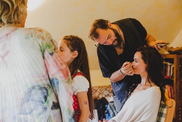 Bride having her makeup done before wedding.