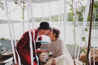 Bride and groom kissing on a boat.