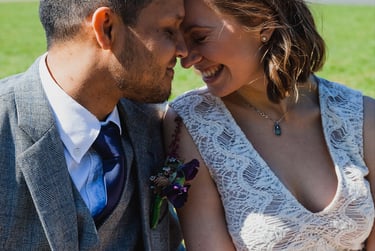 Happy bride and groom touching foreheads.