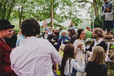 Wedding guests congratulating bride and groom.