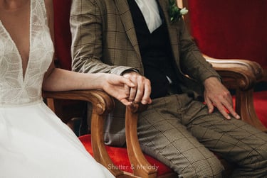 Bride and groom holding hands during a civil wedding ceremony.