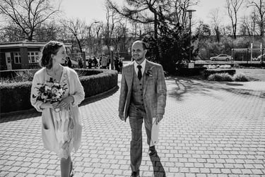 Bride and groom walking towards civil registry building.
