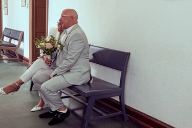 Bride and groom sitting on a bench.
