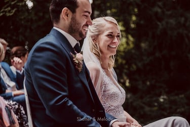 Bride and groom laughing during wedding ceremony.