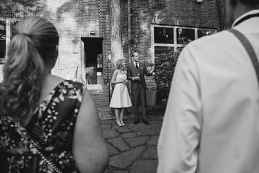 Bride and groom giving a speech outdoors.