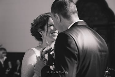 Bride and groom smiling at each other after the ceremony.