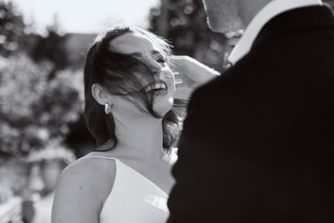 Groom fixing bride's hair.