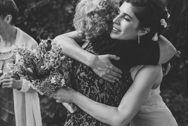 Bride receiving congratulations from a wedding guest.