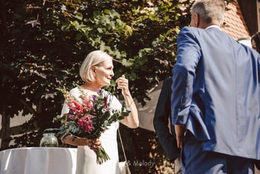 Bride holding her bouquet in the sun.