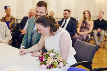 Bride sigining marriage documents.