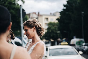 Bride talking to guests on the street.
