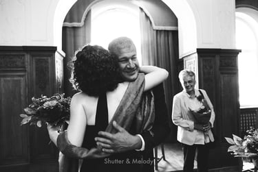Bride hugging her brother after wedding ceremony.