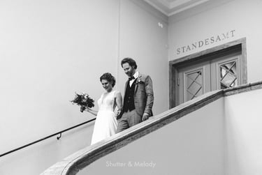 Bride and groom walking down the stairs in the civil registry.