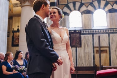 Bride looking at groom in church.