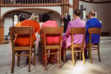 Wedding party photographed from the back in a church.