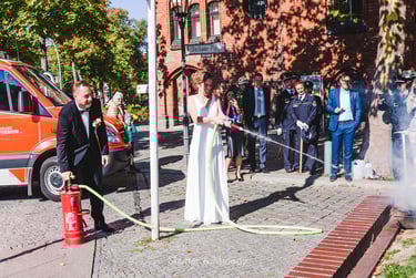 Bride and groom extinguishing a fire.