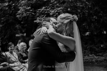 First kiss as husband and wife in an outdoor ceremony..