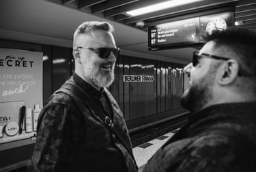 Grooms laughing on the Berliner Strasse U-Bahn platform.