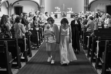 Newlywed couple walking away from the altar after the church ceremony.