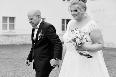 Bride and groom walking in a courtyard.