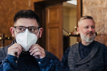 Groom readjusting his mask before wedding ceremony.