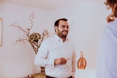 Groom enjoying a glass of champagne before the wedding ceremony.