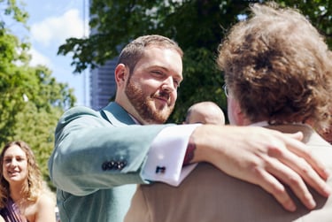 Groom about to hug a wedding guest.