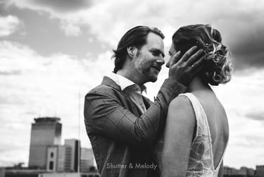 Groom looking deeply into bride's eyes holding her head..