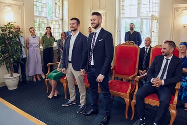 Two grooms standing up during a civil wedding ceremony.
