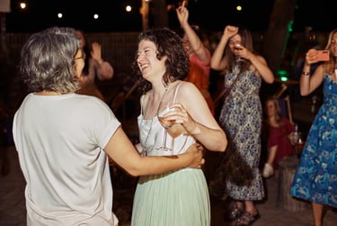 A happy bride dancing with her wife at the wedding reception.