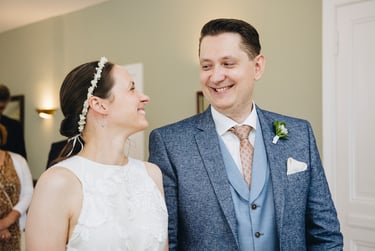 Bride and groom smiling and looking at each other.
