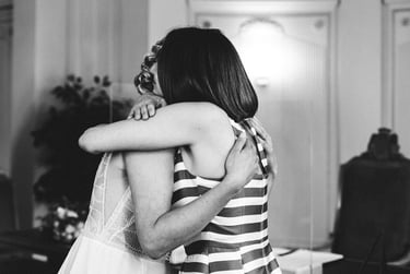 Maid of Honor hugging bride after a civil ceremony.