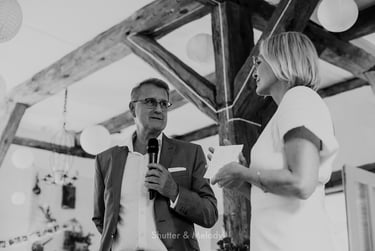 Husband making a speech to his wife and guests.
