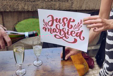 Just married sign next to sparkling wine being poured into a glass.
