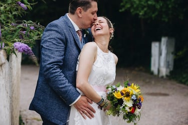 Groom kissing the bride's forehead.