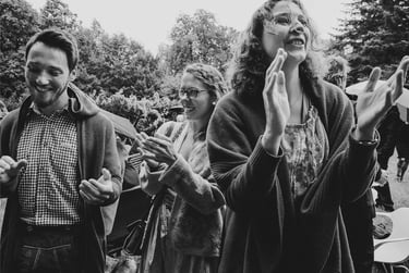 Wedding guests clapping after ceremony.