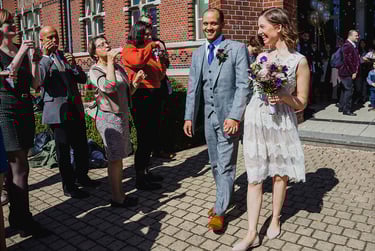 Bride and groom exiting the building of the civil registry.