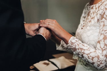 Bride and groom holding hands during a civil ceremony.