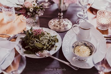 A salad and butter on a table.