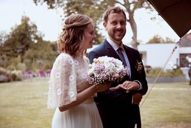 Smiling bride and groom entering reception.