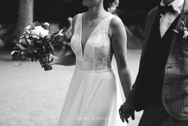Bride and groom holding hands walking.