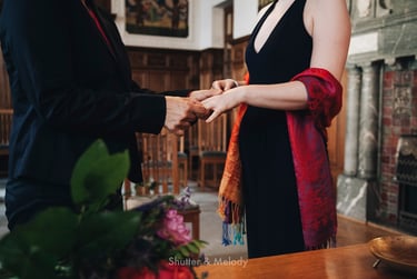 A lesbian couple exchaning rings at a civil ceremony.