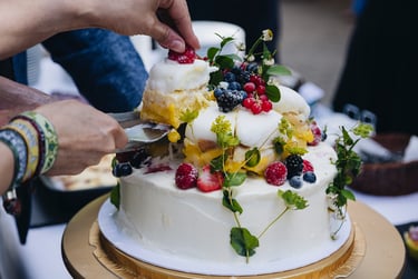 Bride picking up a piece of the ice-cream wedding cake.