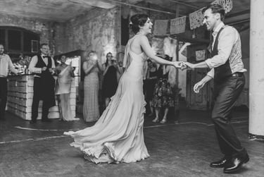 Bride and groom dancing their first dance at the old carpet factory.