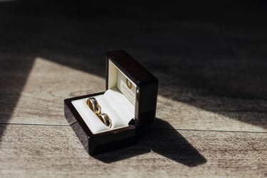 A box with wedding rings lit up by sun rays.