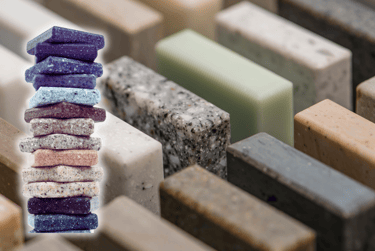 Several granite models in the background and, to the left, a pile of different granites.