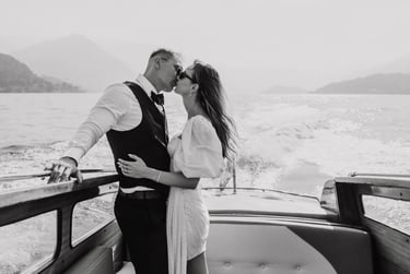 a man and woman kissing on a boat
